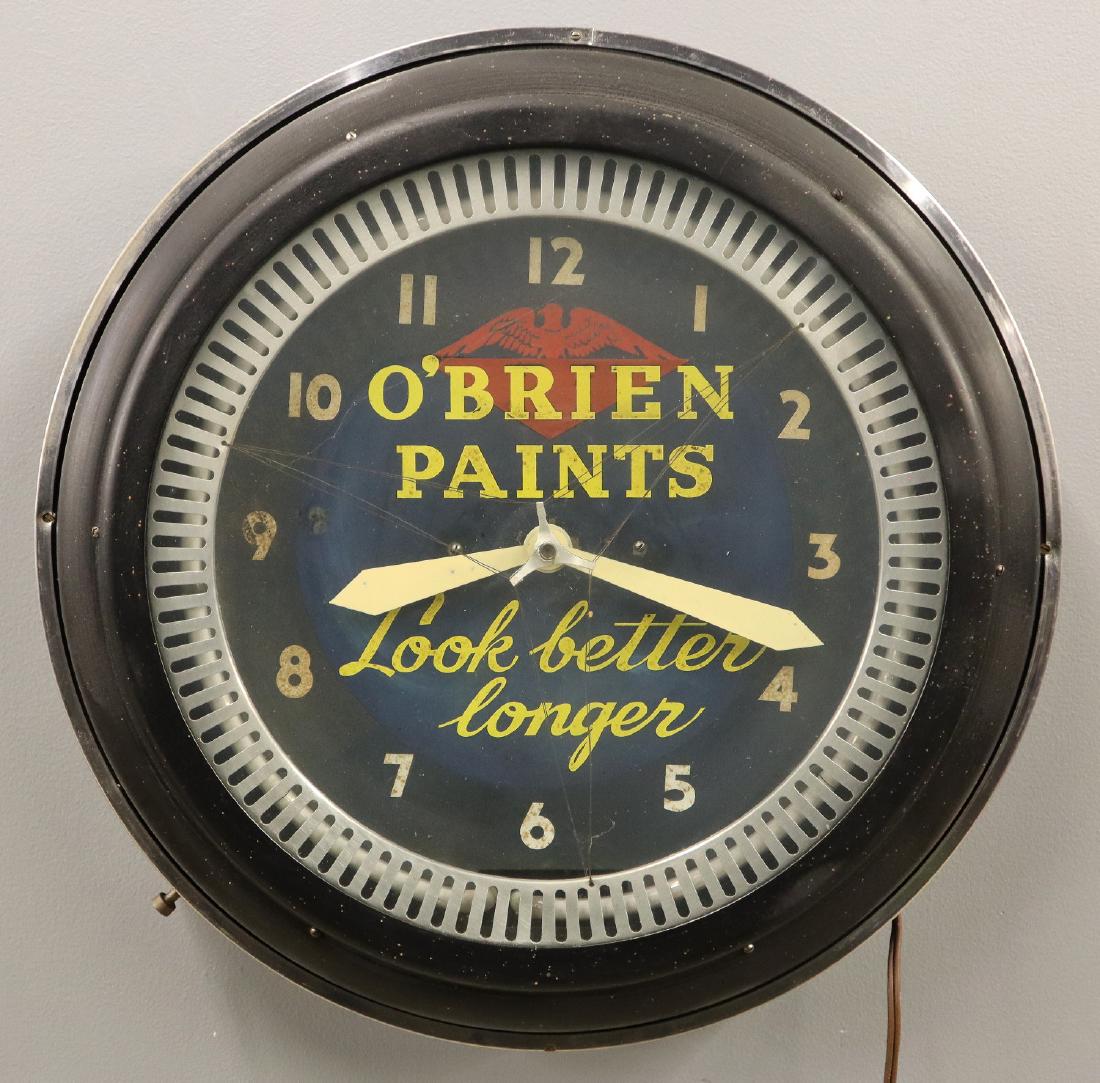 O'Brien Paints Clock: A mid 20th century O'Brien Paints Advertising Clock. Round, electric clock reads "O'Brien Paints Look Better Longer" on the dial, with a metal frame. Clock runs and lights up, some wear. 22 1/4" diame