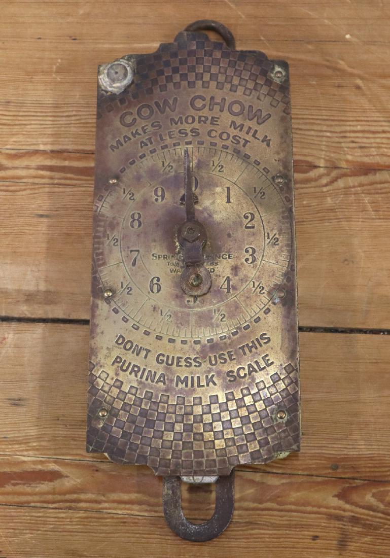 Purina Hanging Feed Scale: An early 20th century Purina Hanging Feed Scale. Advertising scale reads "Cow Chow Makes More Milk at Less Cost Don't Guess Use This Purina Milk Scale". Wear and some denting. 11 1/2" high. ESTIMATE $