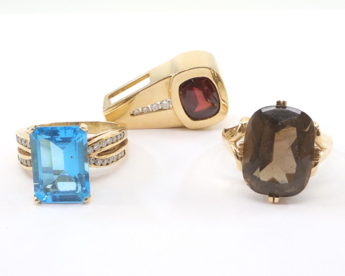 2 Rings & 1 Pendant with Gemstones: Two Rings & One Pendant with Gemstones. Including One emerald cut blue topaz ring with 28 diamonds, 0.42 cttw, One Cushion cut smokey quartz ring, and One Cushion shape buff top Garnet pendant with 4 