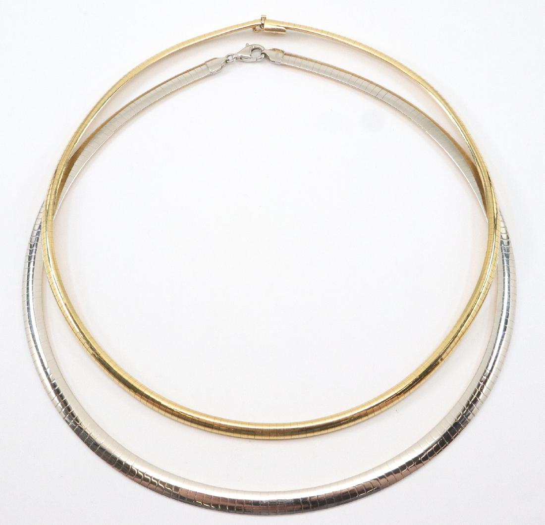 2 14kt Gold Necklaces: Two 14 kt Yellow Gold Chokers. Each having omega style chains, one is two-toned and reversable, stamped "Peru 14K", and the other is of yellow gold, stamped "Italy 14k". Light wear to each. Up to 16" 
