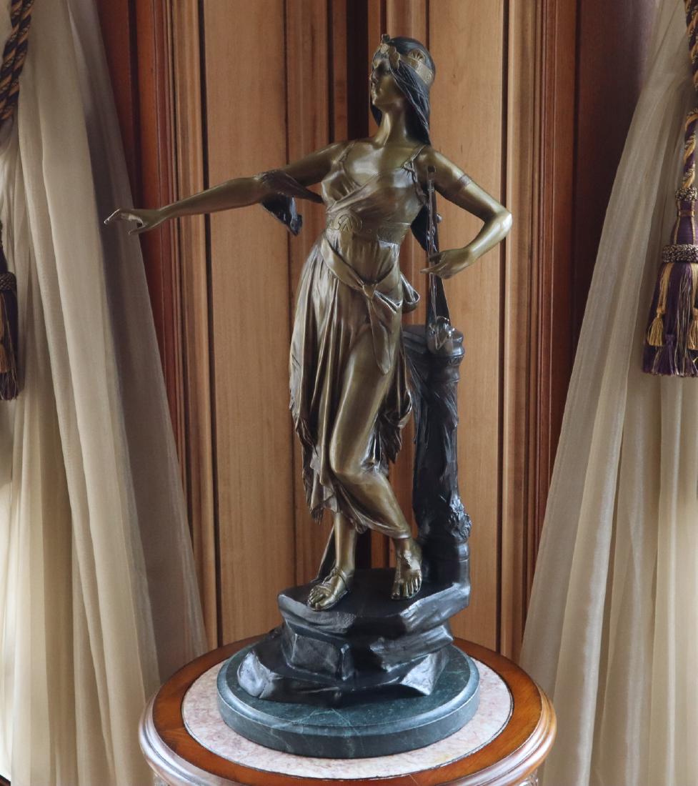 After Edouard Drouot Bronze: After Edouard Drouot, French, 1859-1945. Bronze sculpture of a young woman holding a harp; often referred to as "Muse a la lyre" or "Salome". Signed in the casting; all on a round marble base. Togethe