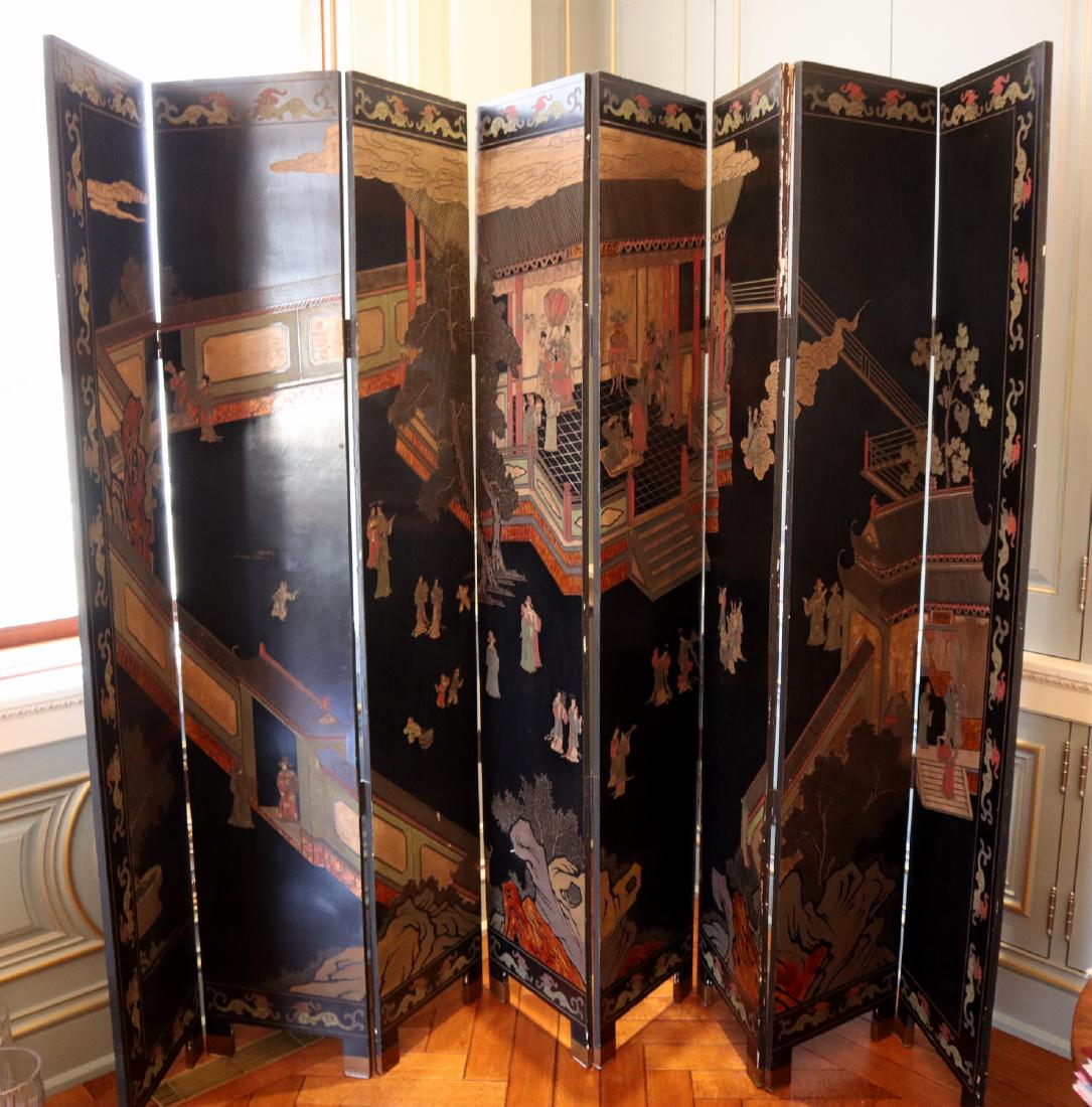 Chinese Folding Screen: A Chinese Folding Screen. Contemporary 8 panel screen with lacquer ground and carved and painted bird and floral motifs at one side and figures in various pursuits at the other. Some cracking, wear, a