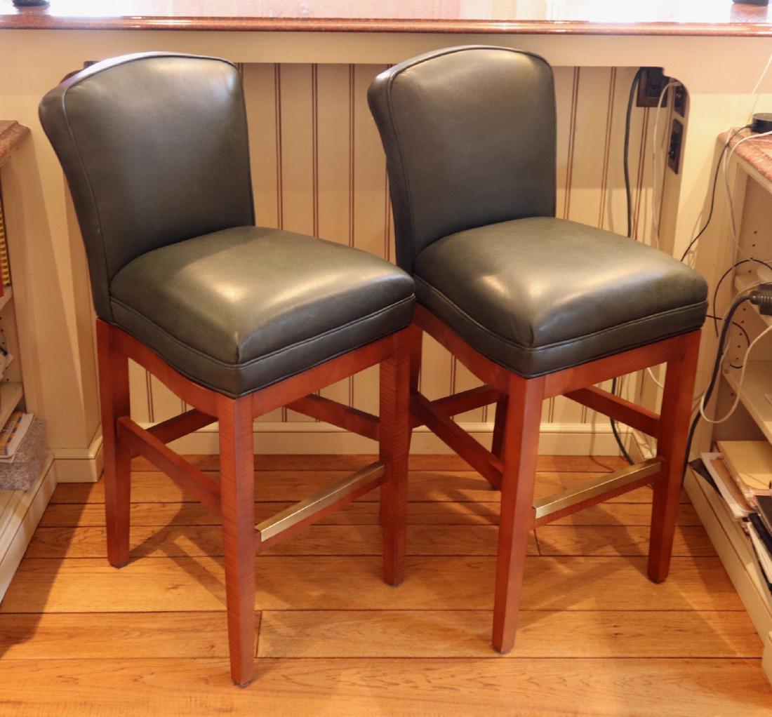 Pr. Of Bar Stools: A Pair of Contemporary Bar Stools. Each having a wood frame, with cherry finish, and dark green leather upholstery and swivel seat. Light wear. 43" high. ESTIMATE $200-400