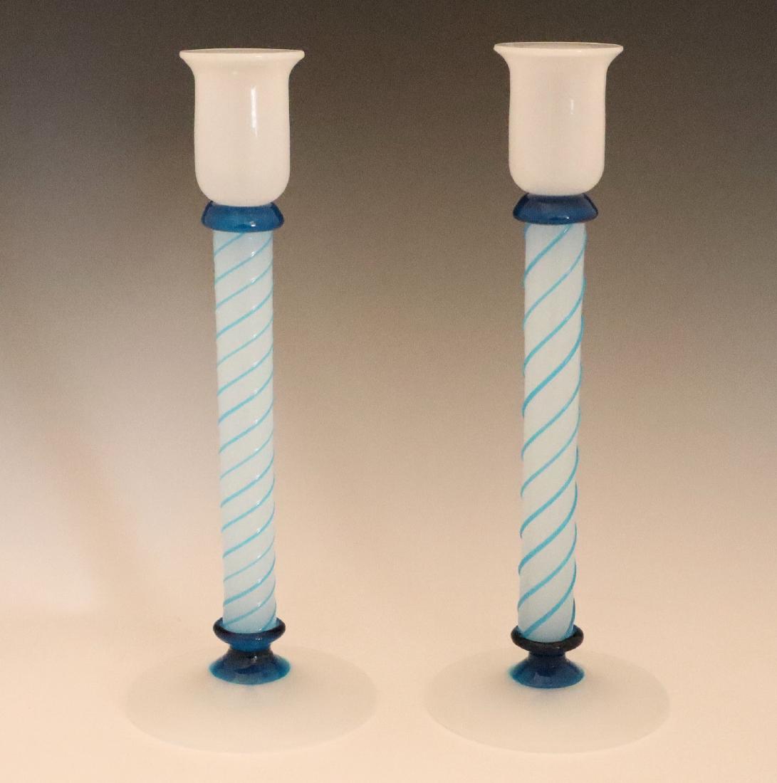 Pr. Candlesticks: A Pair of Art Glass Candlesticks. Opaque white blown glass candlesticks with blue at the collar and foot and applied threading at the stem. Unmarked, slightly rough pontil. Minor wear. 9 3/4" high. ES
