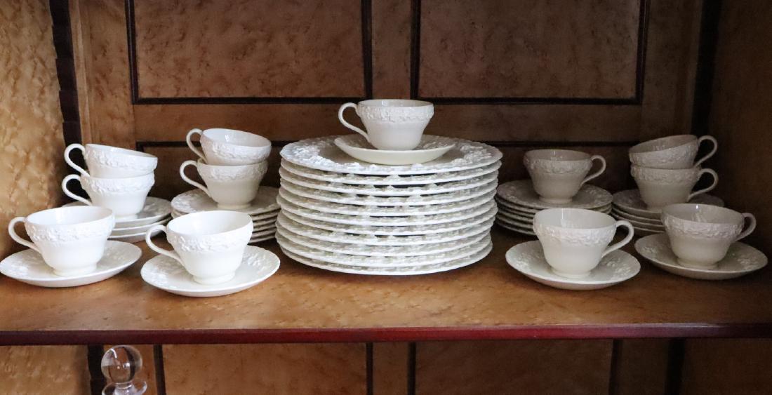 49 pcs of Wedgwood Queen's Ware: Forty-Nine Pieces of Wedgwood "Queen's Ware" Tableware. Including 13 cups, 12 saucers, 12 bread and butter plates, and 12 dinner plates. All are cream colored with embossed rims, and include maker's m