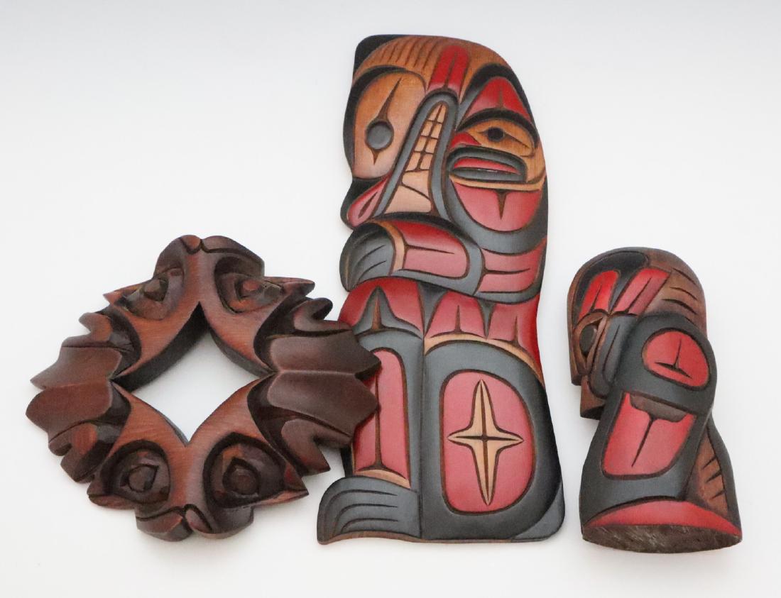 3 Pacific Northwest Carvings: Three Pacific Northwest Carvings. Each is of carved wood and includes one signed "Leo Mitchell", one entitled "4 Watchers" and signed "Peter Billy Ehattesaht Nation Zeballos B.C." on the reverse, and 