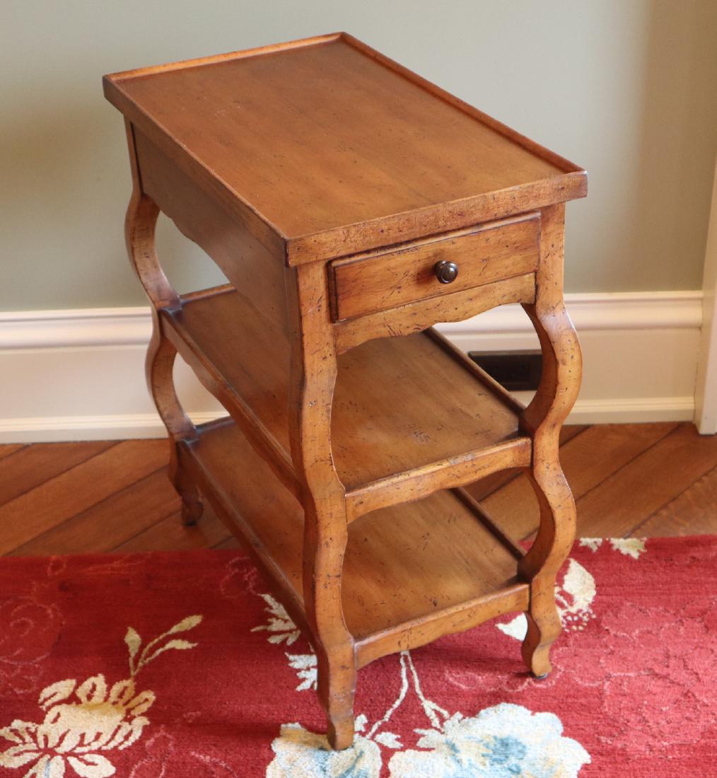 Baker End Table: A Baker Milling Road Collection End Table. Having a single drawer and two wood shelves. Light wear. 22" x 12 1/2" x 25" h. ESTIMATE $100-200