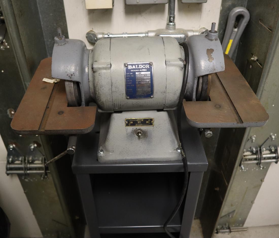 Baldor 1/2 hp Grinder/Sharpener: A Baldor 1/2 hp grinder/sharpener with steel tables on stand. Some wear. ESTIMATE $100-200