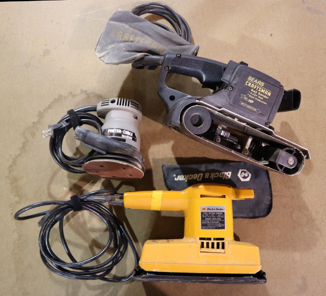 Three hand held sanders: Three hand held electric sanders. Includes a Craftsman 4 x 21" belt sander, Black & Decker pad sander and a Porter Cable orbital sander. Some wear. ESTIMATE $30-40