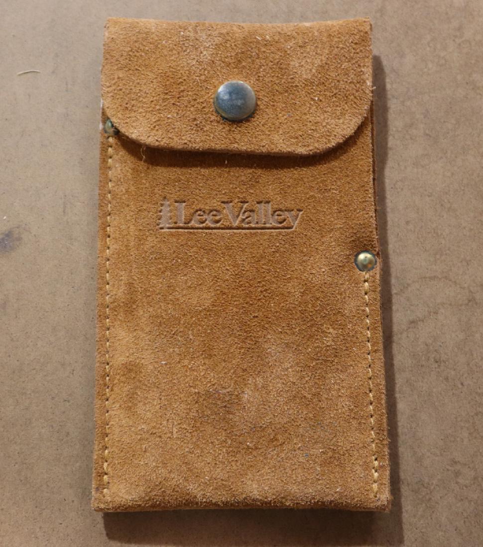 2 Lee Valley Scrapers: Two Lee Valley steel scrapers in a leather pouch. Slight wear. ESTIMATE $20-30