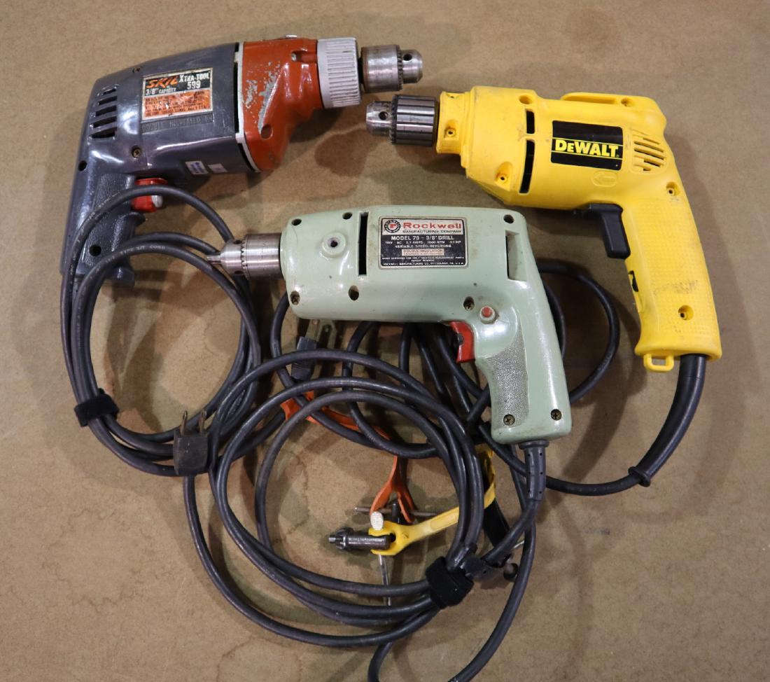 3 3/8" Electric Drills: Three corded 3/8" electric drills. By DeWalt, Skil and Rockwell. Some wear. ESTIMATE $20-30