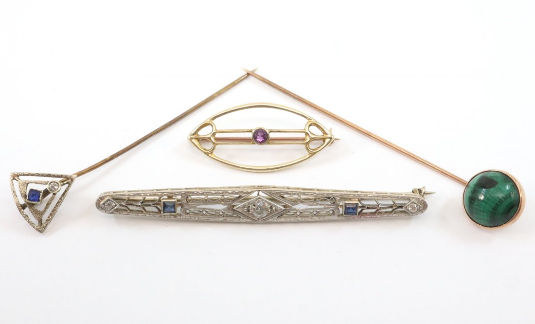 4 Gold Pins: Four Gold Pins. Including 2 bar pins and 2 stick pins, featuring Amethyst, Diamonds, Malachite, and Synthetic Sapphires. 1 marked "14K", 1 marked "10K", and 2 unmarked. Surface wear to each, one pinba