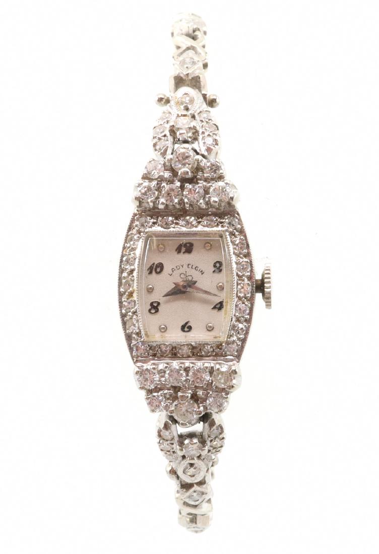 Ladies Elgin Diamond Watch: A Mid-Century Lady Elgin Diamond & Gold Wrist Watch. 21 jewel movement wrist watch with 1.0 cttw diamonds, H/I color, SI clarity, set in 14 kt white gold. Marked "Lady Elgin" on the face, stamped "14K