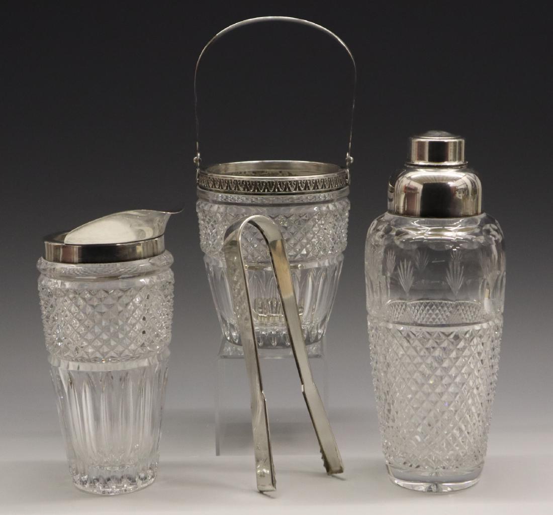 4 pcs Glass & Silver Cocktail Set: An Italian 20th Century Four Piece Glass & .800 Silver Cocktail Set. Including 1 pair of tongs, 1 pressed glass ice bucket with silver handle and collar, 1 cut glass cocktail shaker with silver cap an