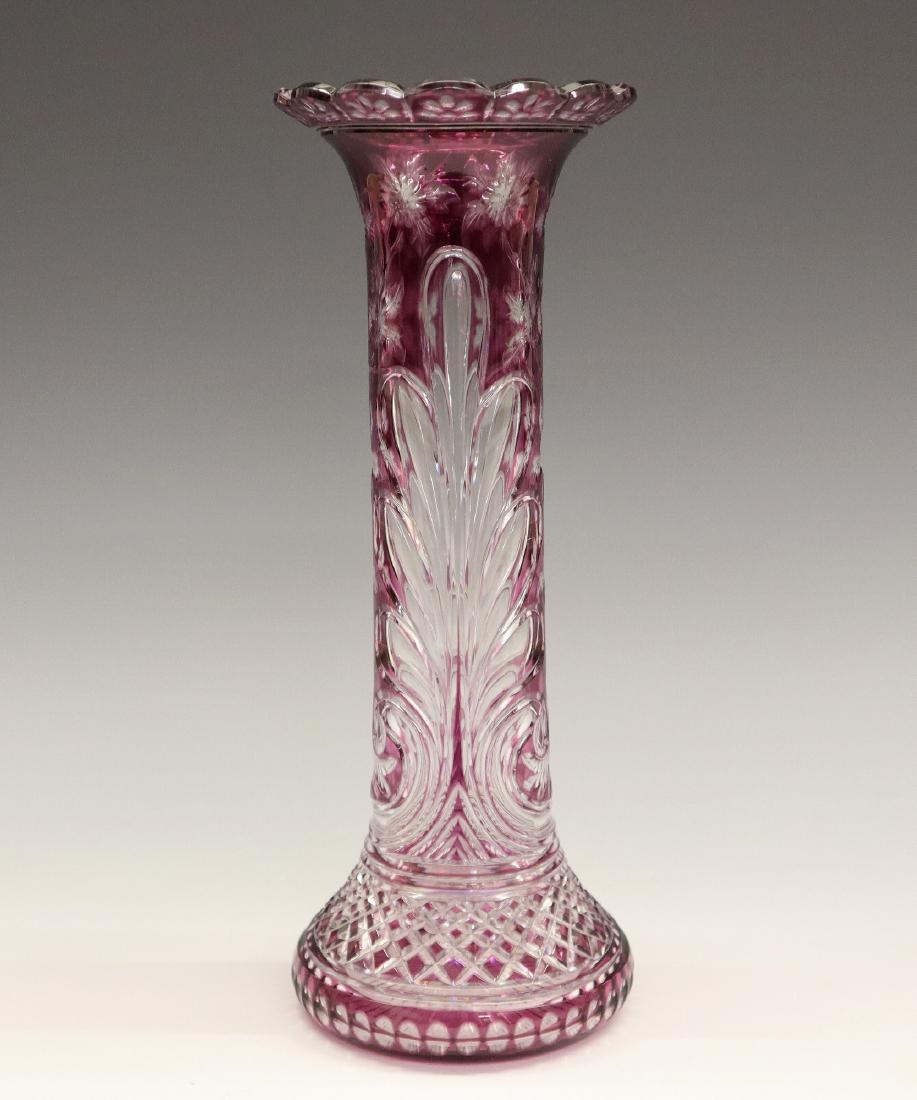 Amethyst to Clear Cut Glass Vase: A Turn of the Century Stevens & Williams Amethyst to Clear Intaglio Cut Glass Vase. Having a scalloped rim with floral and scrolling leaf motifs about the neck and body, and diamond and dot patterns a