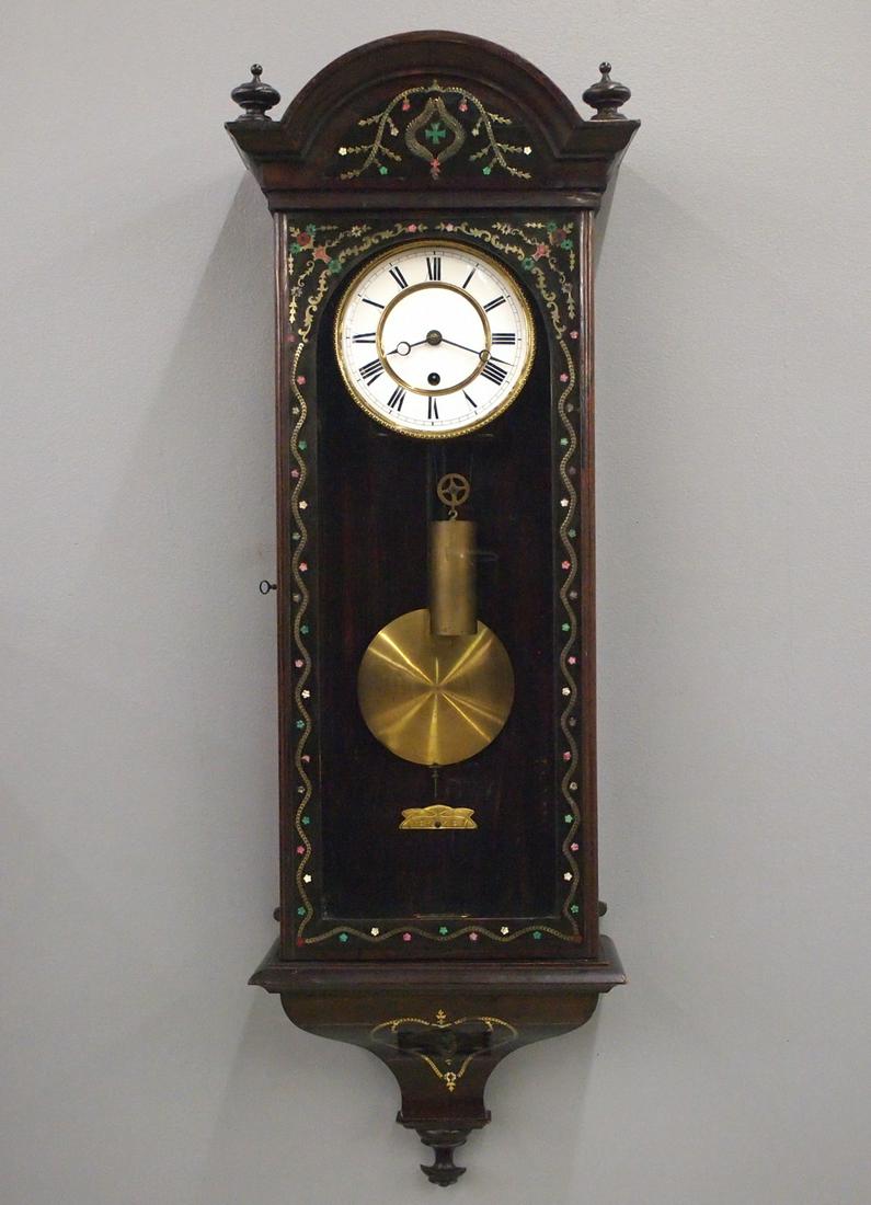 Inlaid Vienna Regulator: A mid 19th century Vienna Regulator Wall Clock. 8-day weight driven time only movement having a flat porcelain dial with Roman numerals and embossed Brass bezel. Rosewood case with fine Brass inlaid d