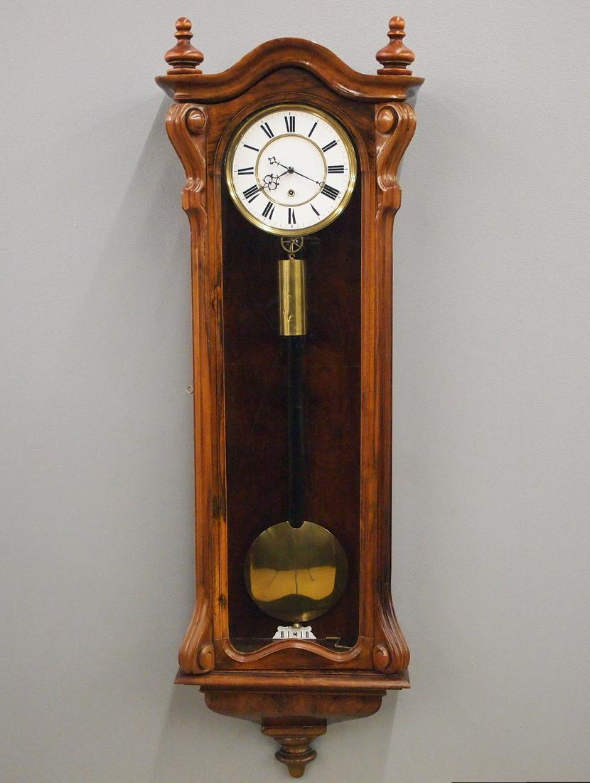 30 day Vienna Regulator Wall Clock: A mid 19th century Vienna Regulator wall clock. 30-day weight driven time only movement having a two part porcelain dial with Roman numerals and Brass molded brass bezel. Transitional style case with