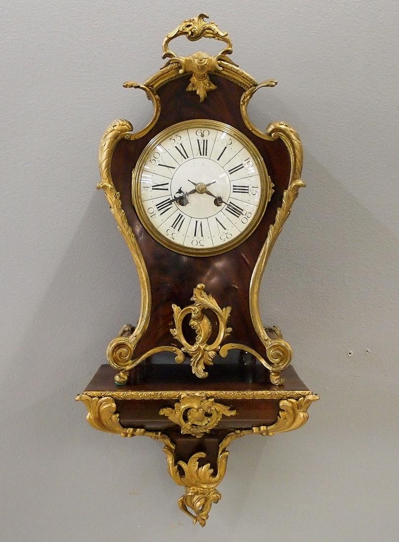 French Bracket wall clock: An early 20th century French Bracket wall clock by Vincenti, Paris. 8-day time and strike movement with porcelain dial and Roman numerals. Mahogany Louis XV style case and bracket case with applied Gi