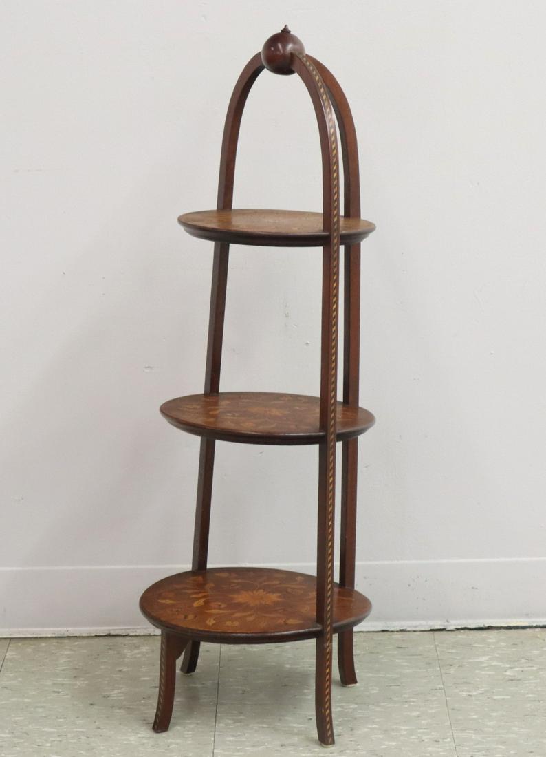 1930s Cake Stand: A 1930s Cake Stand. Mahogany cake stand is comprised of three shelves with floral inlay and striped parquetry. Old finish with minor wear. 35" high. ESTIMATE $100-150