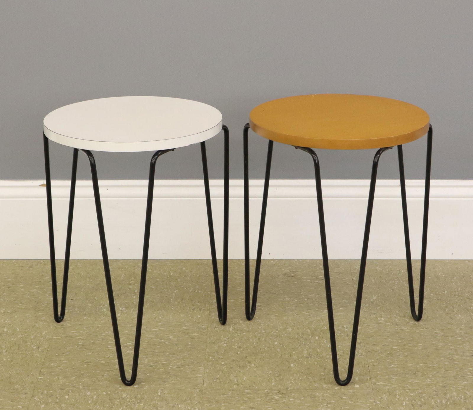 Two Knoll hairpin stack tables: Two Mid Mod hairpin stack tables by Florence Knoll. Circular tops, one Maple one White Formica with Black painted metal "hairpin" bases. Minor wear, light surface scratches. Each 18" high. ESTIMATE $2