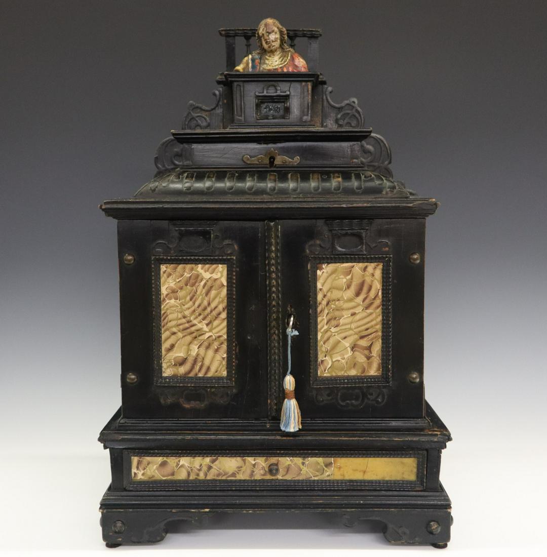 Italian Jewel Casket: An 18th Century Italian Jewel Casket. Carved and ebonized wood with carved and polychrome Santo at the top of a small box (perhaps a reliquary), which rests above a small hinged compartment that is at