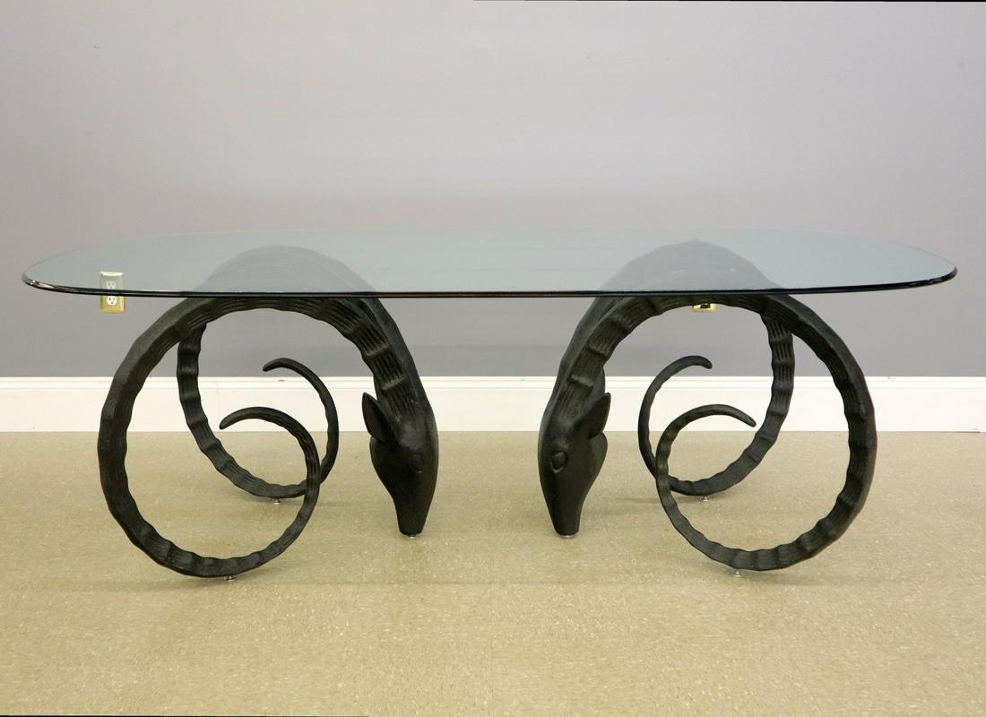 Ibex Dining Table After Chervet: A Late 20th Century "Ibex" Dining Table, after Alain Chervet, b. 1944. Comprised of an oval glass top and two cast bases, each in the form of Ibex. Unmarked. Light wear. 48 x 72 x 29" high. ESTIMATE $