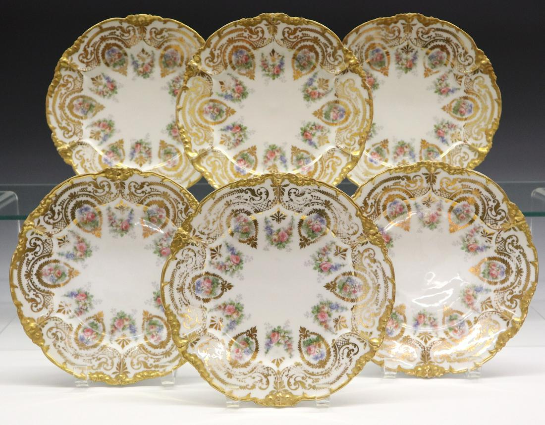 12 Jean Pouyat/Limoges Plates: A Set of Twelve Limoges Plates by Jean Pouyat. Each having transfer decorated floral motifs with gilt accents. Stamped green maker's mark of "J.P./L. France". Wear to the decoration, some rim flakes. 