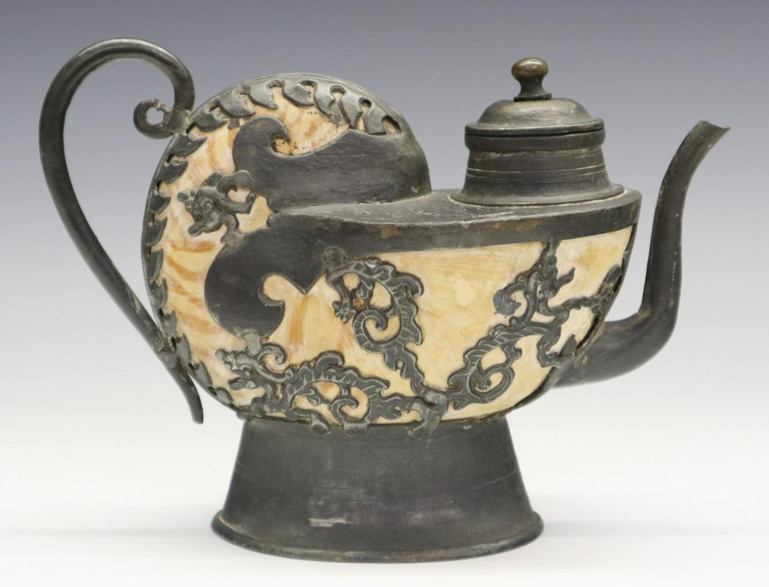 Asian Nautilus Teapot: An 18th century Asian Nautilus Teapot. Shell vessel with applied metal fittings, including a curved handle, stylized dragon motif, spout, and oval footed base. Unmarked. Wear and some damage. 8 1/4 x 