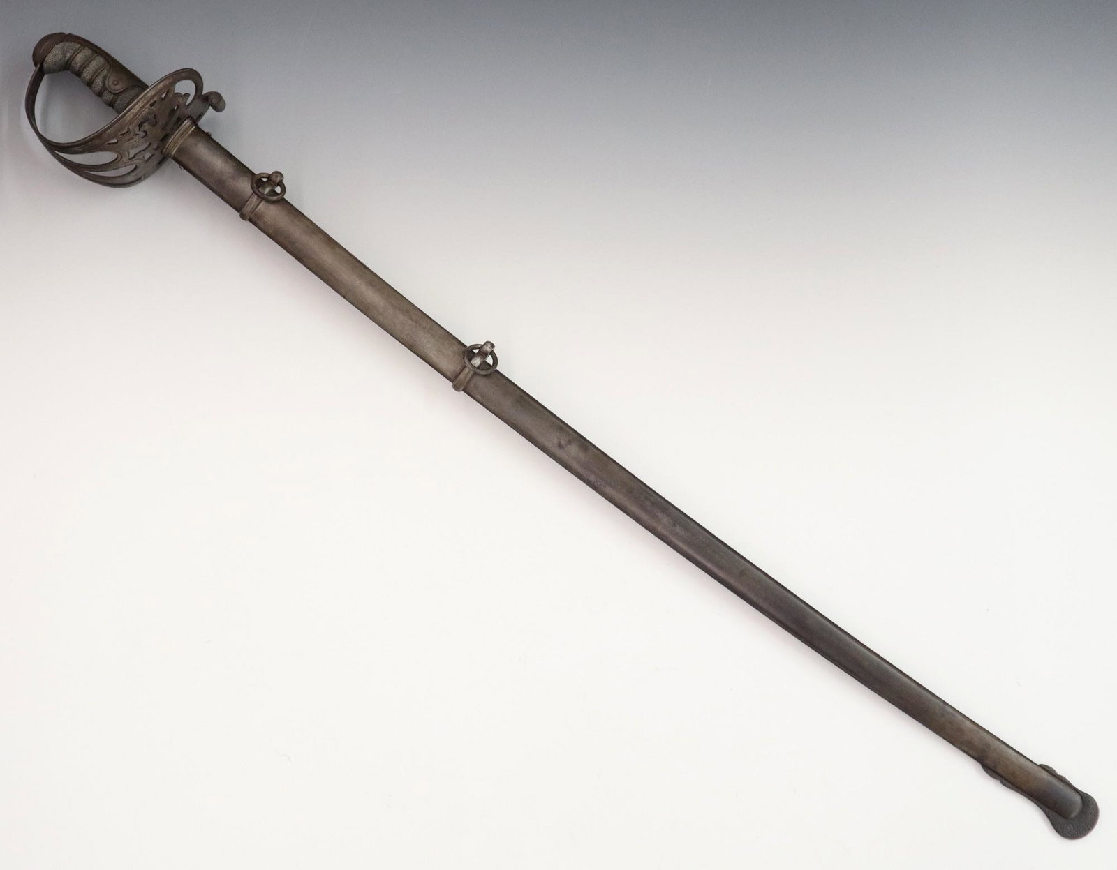 Civil War Sword: A Civil War Era Sword. German (Prussia) made Civil War era sword with pierced guard having "E. Pluribus Unum" above and Eagle with spread wings and "US", and shagreen wrapped handle; ricasso is stampe