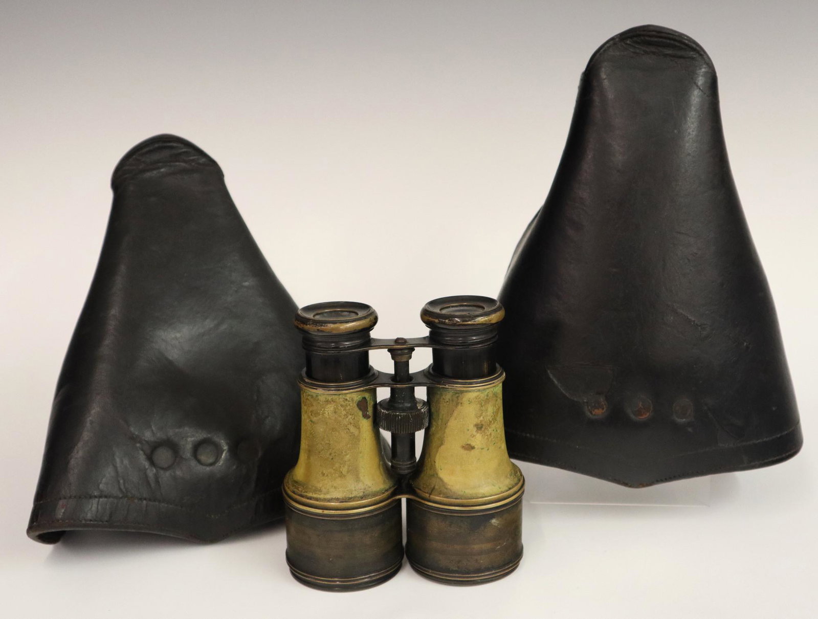 McClellan Stirrups & Binoculars: A Pair of McClellan Saddle Stirrups & Binoculars. Including 1 pair of black leather and bent wood, one with "Maj. H.G.O.W." painted at the underside, together with a pair of binoculars with maker's ma