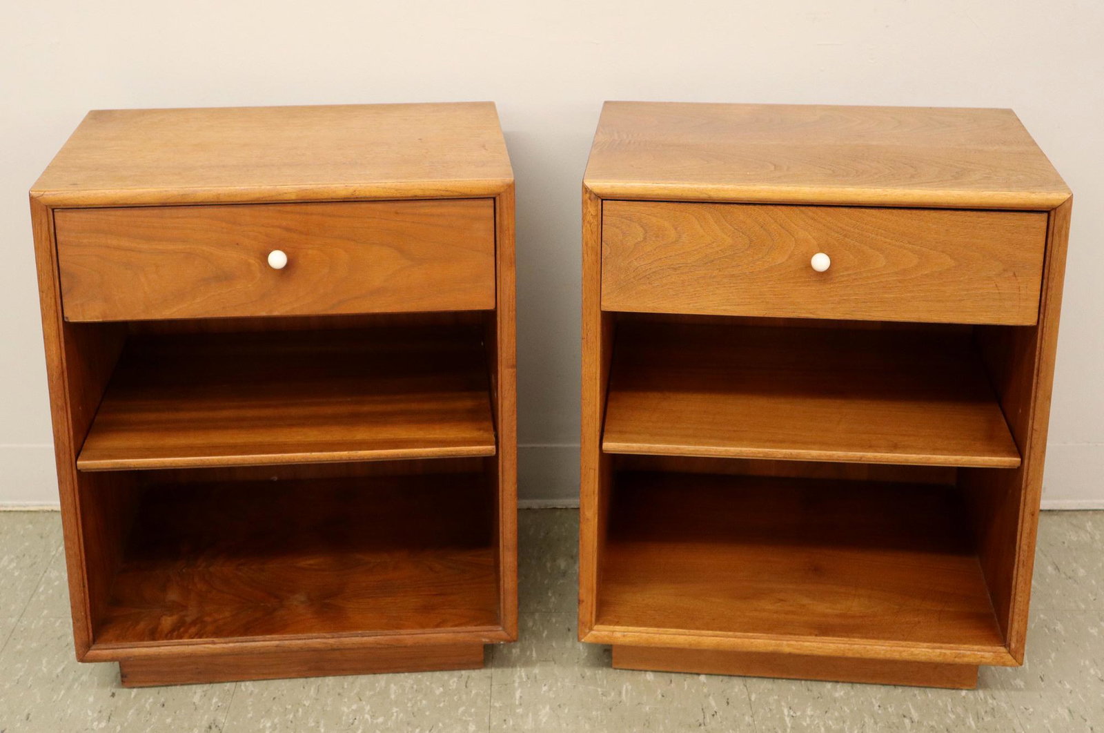 Pr Drexel Declaration Nightstands: A pair of 1960's Drexel "Declaration" nightstands by Kipp Stewart. Walnut construction with one drawer above two open shelves #801-6105-2. Original finish with slight wear, some light watermarks on to