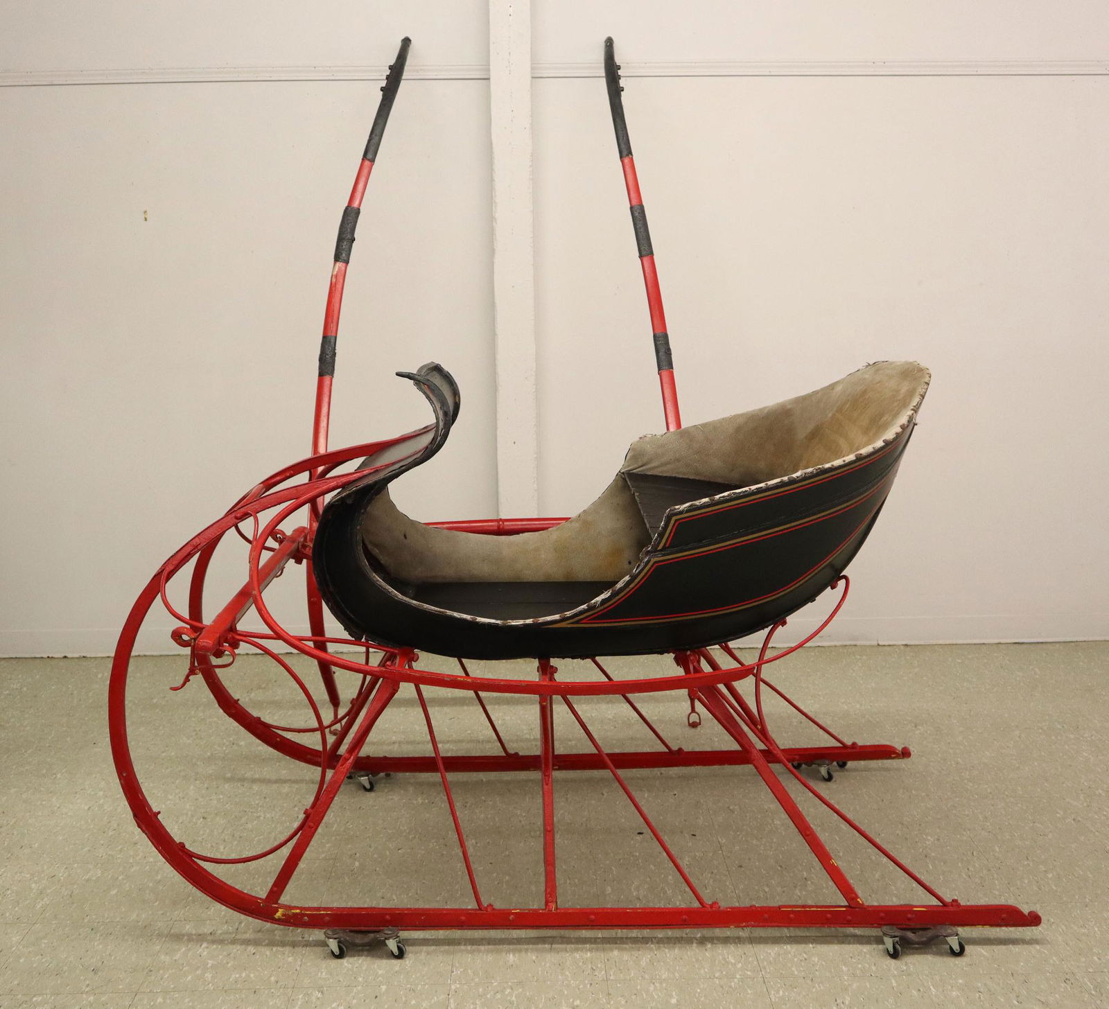 One Horse Cutter: A turn of the century horse drawn cutter. Single bench seat with Black painted body and Red pinstriping. Older re-paint with some wear, flaking, minor damage, seat re-upholstered. 70" long plus the re