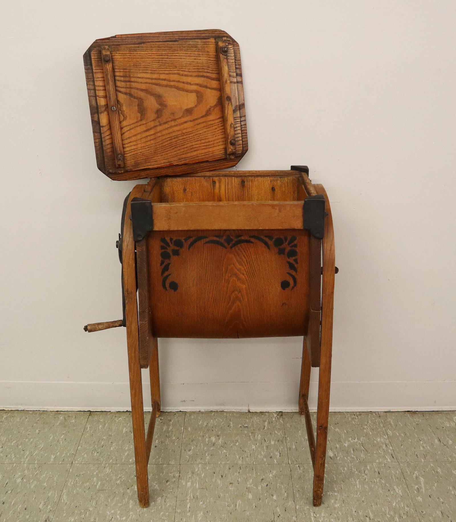 Butter Churn: A turn of the century. Wooden box with bentwood legs, metal gears and crank handle. Older finish with stenciled decoration, minor wear. 31" high. ESTIMATE $100-150