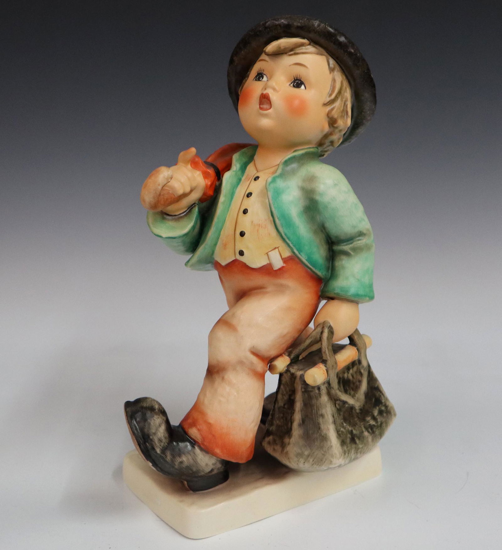Goebel/Hummel Figure: A Goebel/Hummel porcelain figure with hand painted decoration. "Merry Wanderer" #7/II. Printed and impressed marks. Slight wear. 10" high. ESTIMATE $100-200