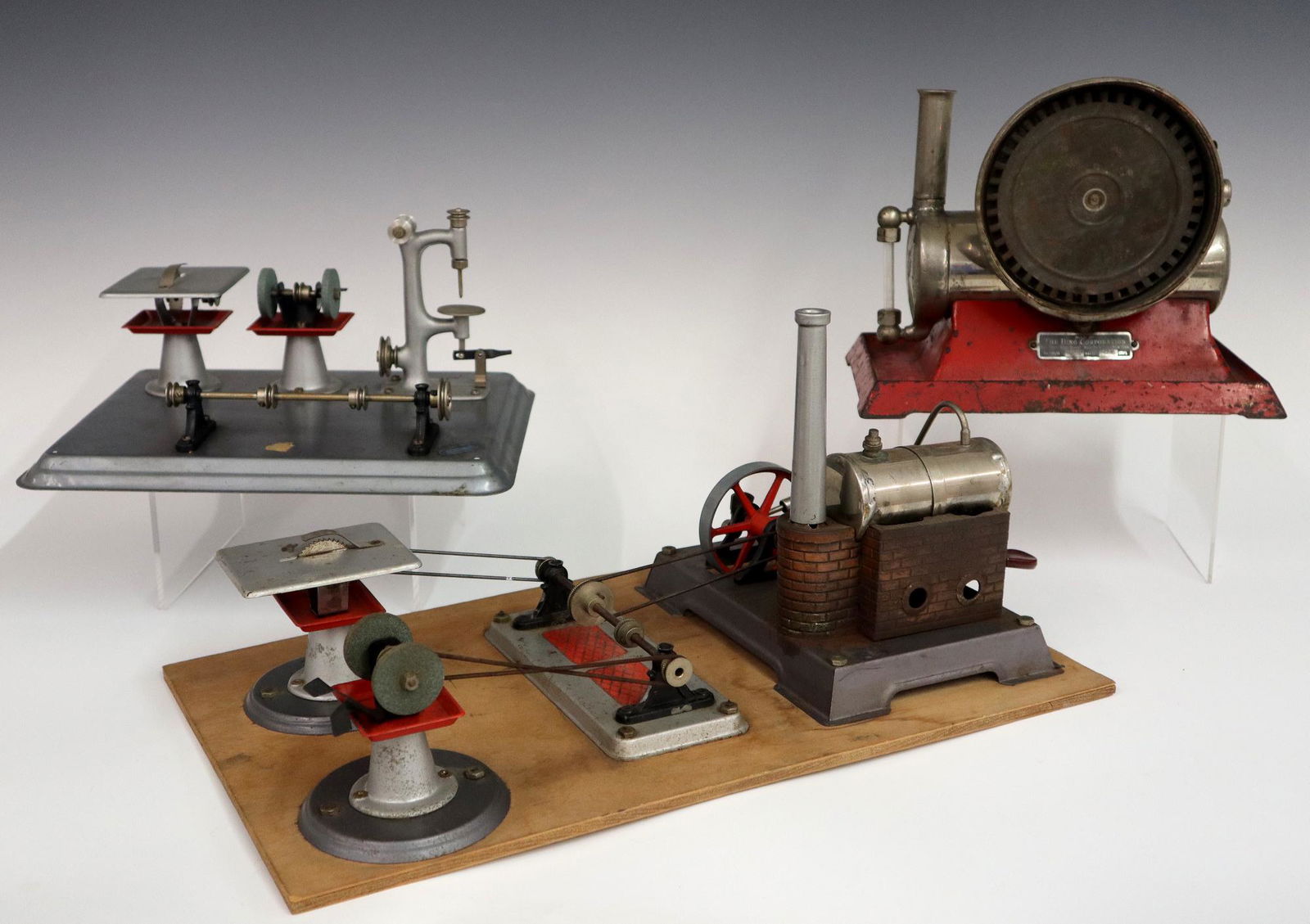 3 Model Steam Engines: Three 20th century model steam engines/workshops. Includes a Bing electric engine, a workshop with two tools and a Wilesco engine with three tools. Old finish with wear and some damage, soldered repai