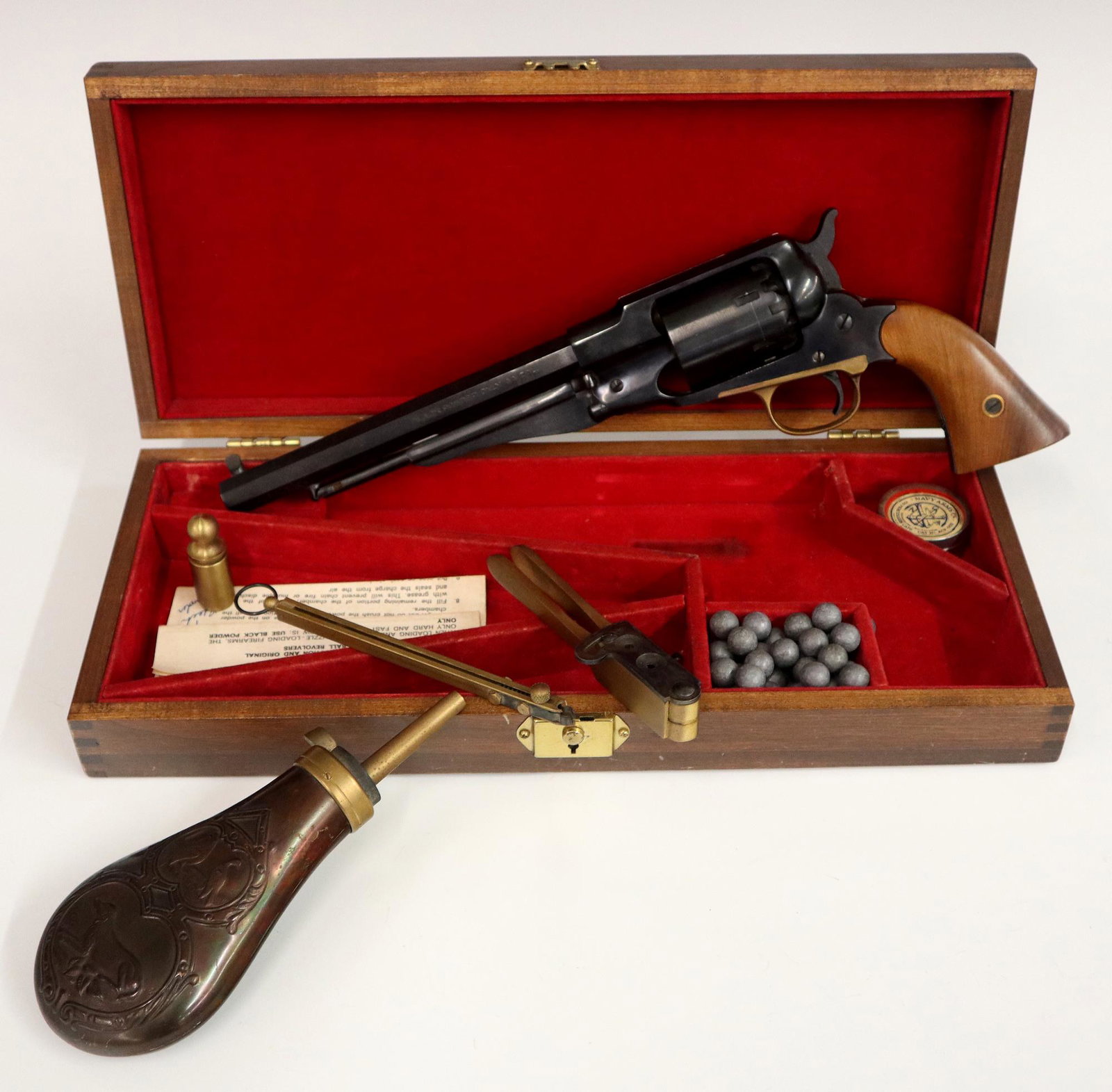 Italian Black Powder Revolver: An Italian .44 Caliber Black Powder Six Shot Percussion Revolver. Includes the revolver, a powder horn, a bullet mold, percussion caps, balls, and a cap dispenser holder all fitted within a pine box. 