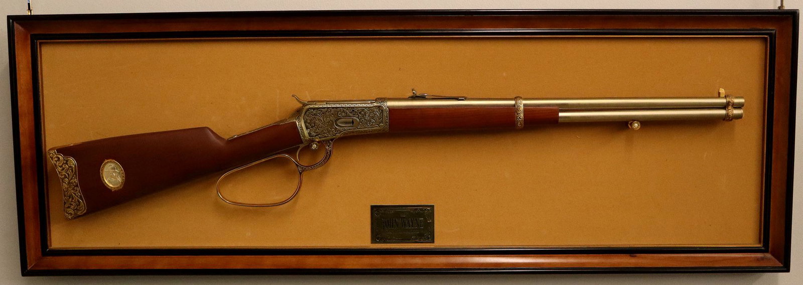 Franklin Mint Rifle: Franklin Mint John Wayne Commemorative 1892 Model 44-40 non-firing Replica Rifle. With engraved case and lever, walnut stock, and saddle ring at the side. Mounted within frame, Serial #JW987672. Minor
