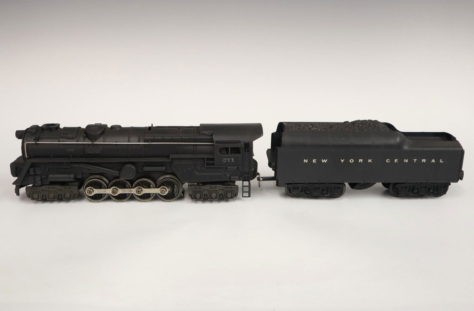 Lionel Locomotive and Tender: A Post-War Lionel O Gauge Locomotive #671 with Tender #2671W. Minor wear and soiling. 19 1/4" long overall. ESTIMATE $50-100