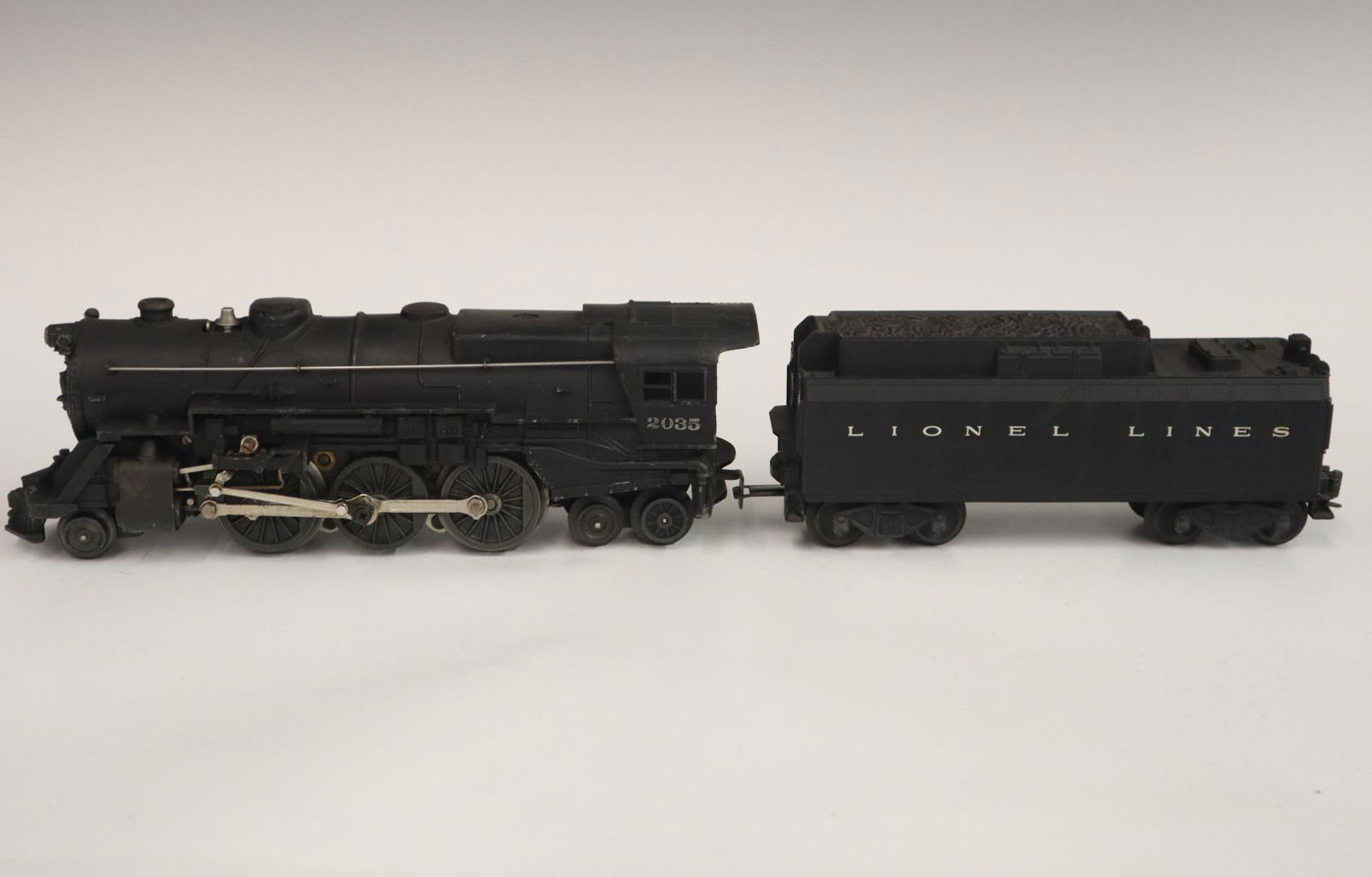 Lionel Locomotive and Tender: A Post-War Lionel O Gauge Locomotive #2035 with Original Tender. Minor wear and soiling. 18 1/2" long overall. ESTIMATE $50-100