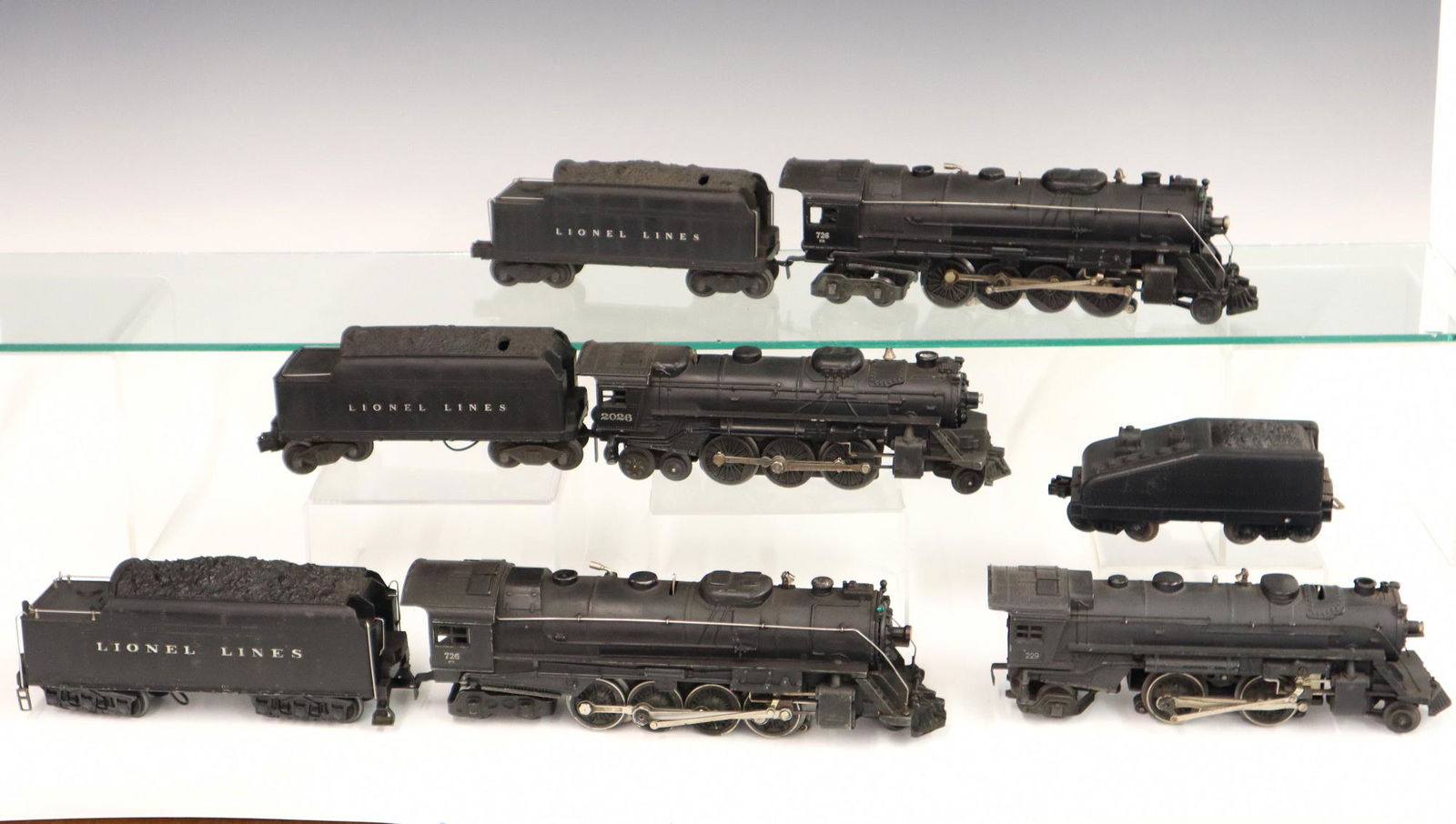 4 Lionel Locomotives w/Tenders: Four Post-War Lionel O Gauge Locomotives with Tenders. Including locomotive #229 and unmarked tender, locomotive #726RR and tender (number is worn), locomotive #726RR and tender #671W, and locomotive