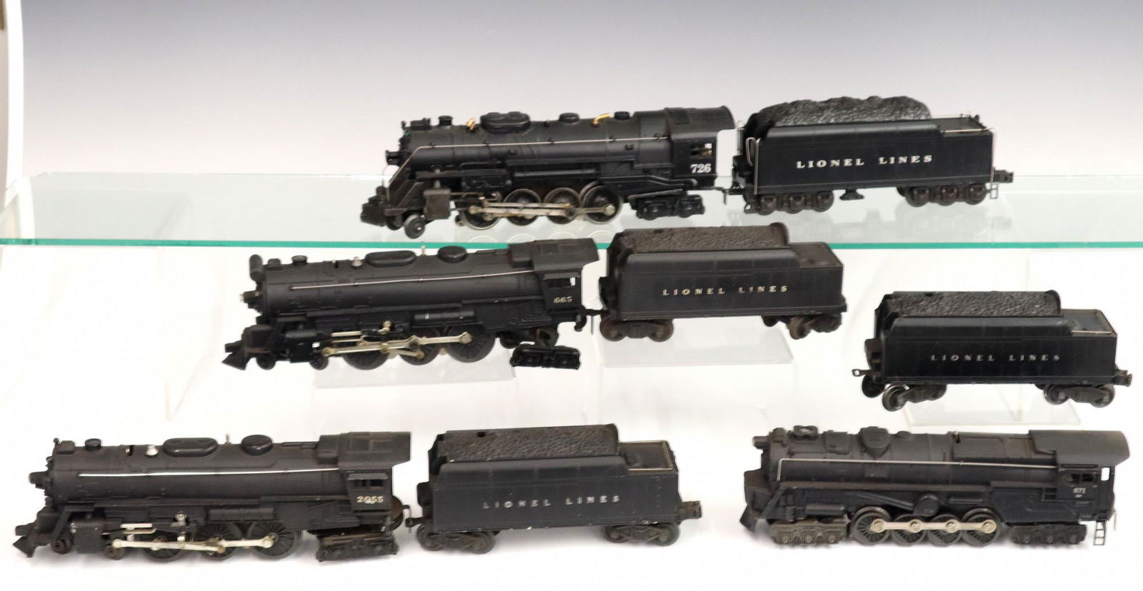 4 Lionel Locomotives w/Tenders: Four Post-War Lionel O Gauge Locomotives with Tenders. Including locomotive #665 and tender #6466W, locomotive #2055 and tender #6466WX, locomotive #671RR and unmarked tender, and locomotive #726 and