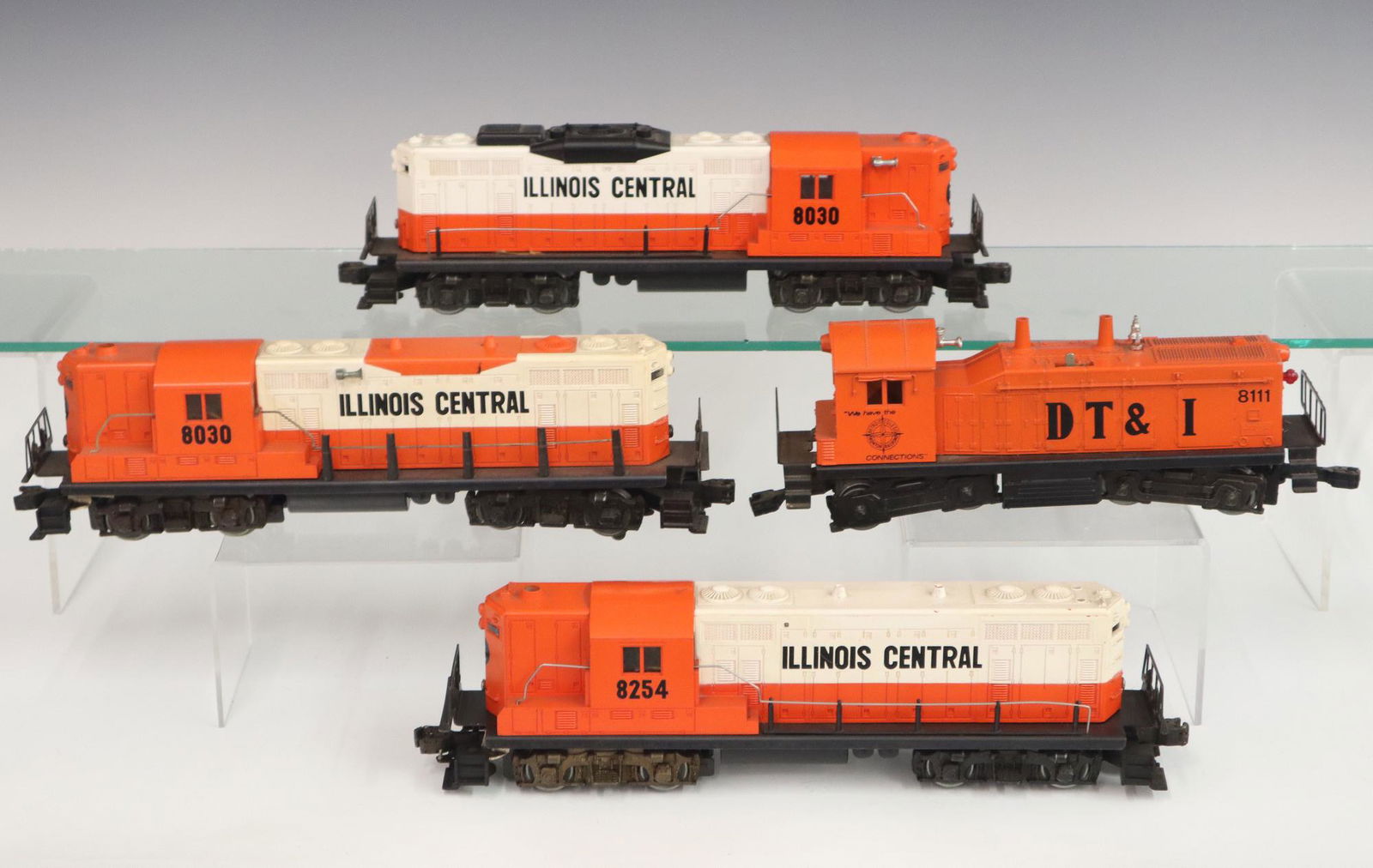 4 Lionel Locomotives: Four Post-War Lionel O Gauge Locomotives. All are orange and white Diesel powered locomotives, includes an Illinois Central #8254, 2 Illinois Central #8030, and a DT & I (Detroit, Toledo, Ironton) #81