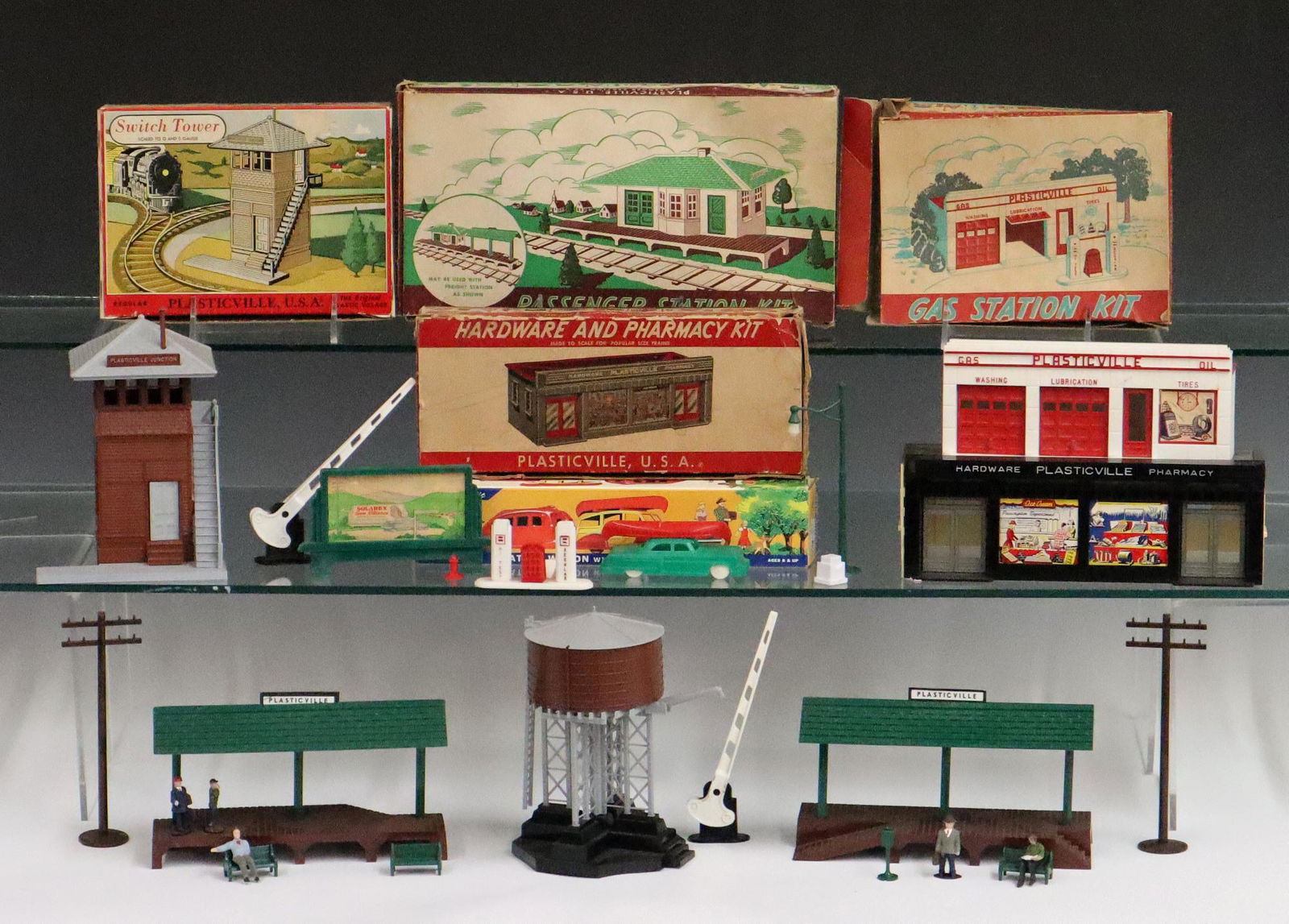 Lionel Plastic-ville Set Up: A Post-War Lionel Set up for the "Town of Plastic-ville". Includes a passenger station kit, a switch tower, a gas station kit, a station wagon with camper and canoe, a hardware and pharmacy kit with o