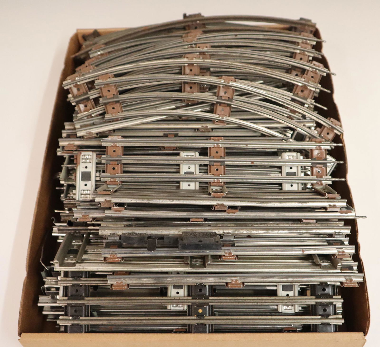 73 pcs of Lionel Track: Seventy-Three Pieces of O gauge Post-War Lionel Track. Includes 35 curves, up to 12" long, and 38 straights, up to 10" long. Light wear overall. ESTIMATE $50-100