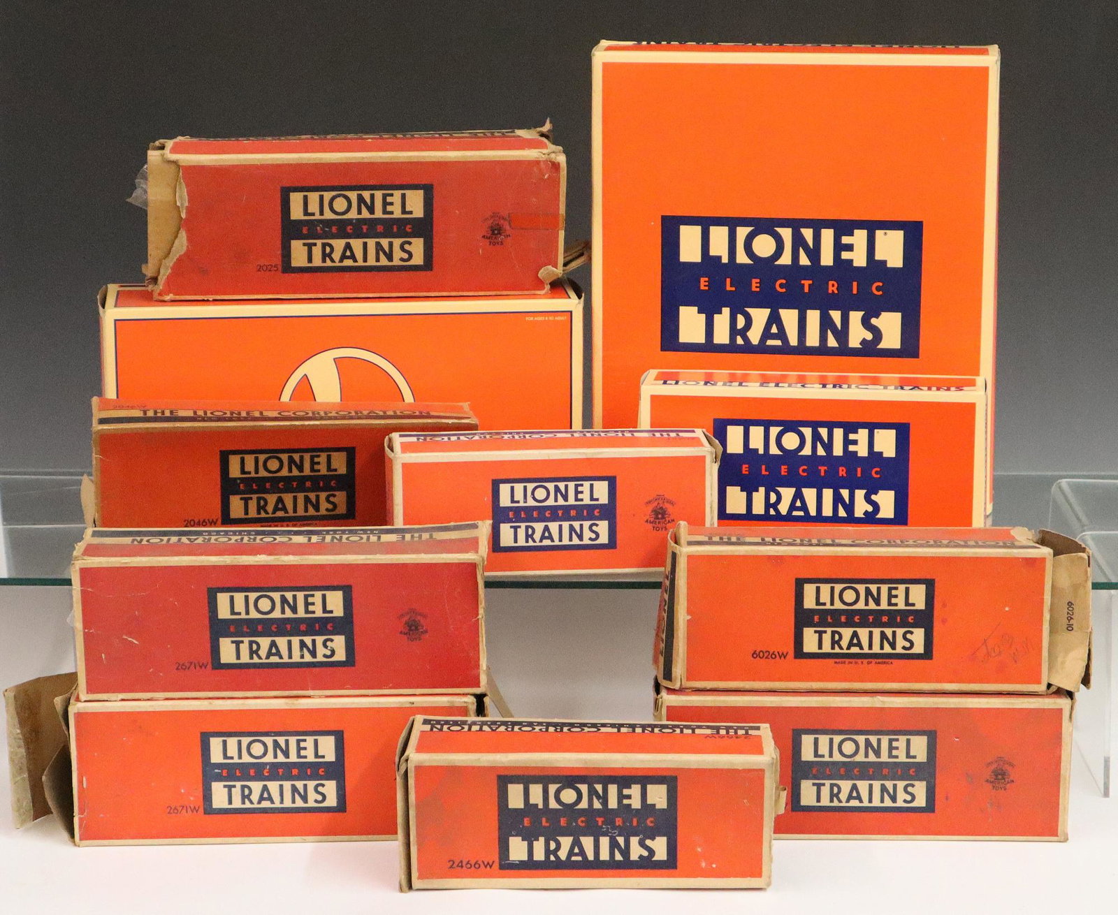 14 Lionel Trains Boxes: Fourteen Lionel Trains Boxes. Consisting of 12 small boxes including #2046W, #2466W, #6066T, #6026W, #2671W (3), #2025, 2 Ford Hopper #6-52031, Ford Tank Car #6-52029, Ford Gondola #6-52030 (a large b