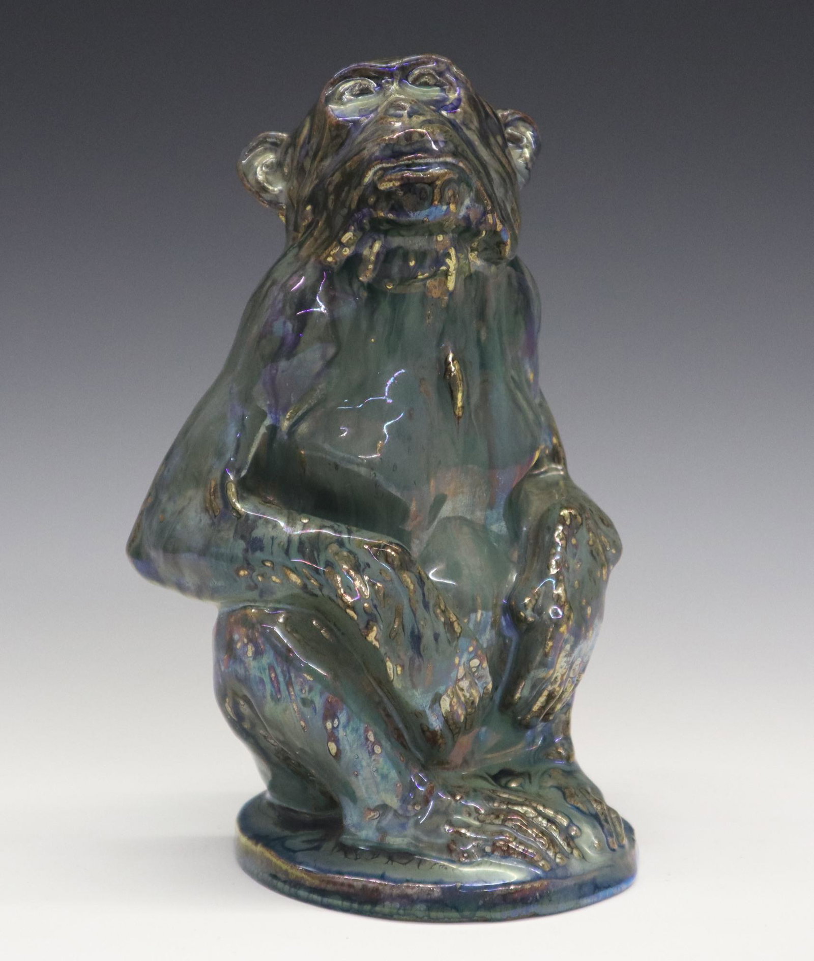 A. Cytere/Rambervillers Pottery Figure: Alphonse Cytere for Rambervillers Glazed Pottery Figure. Having a green/blue lustre glaze over the figure of a seated monkey. Impressed mark at the underside "Rambervillers Vosges" which encircles "Gr