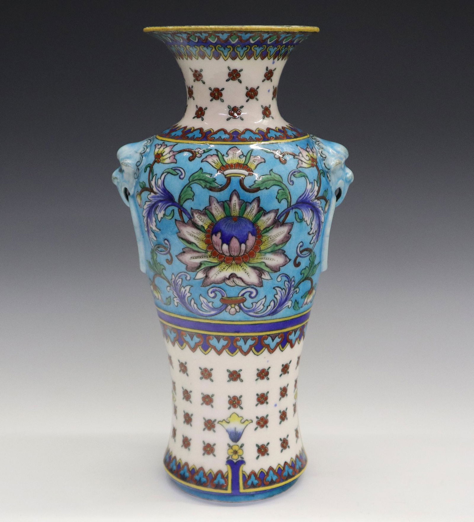 Th. Deck Vase: A Late 19th Century Theodore Deck Glazed Earthenware Vase. Chinoiserie vase decorated with stylized rows of flowers at the neck and base, molded mask and ring forms at either side, with scrolling leaf