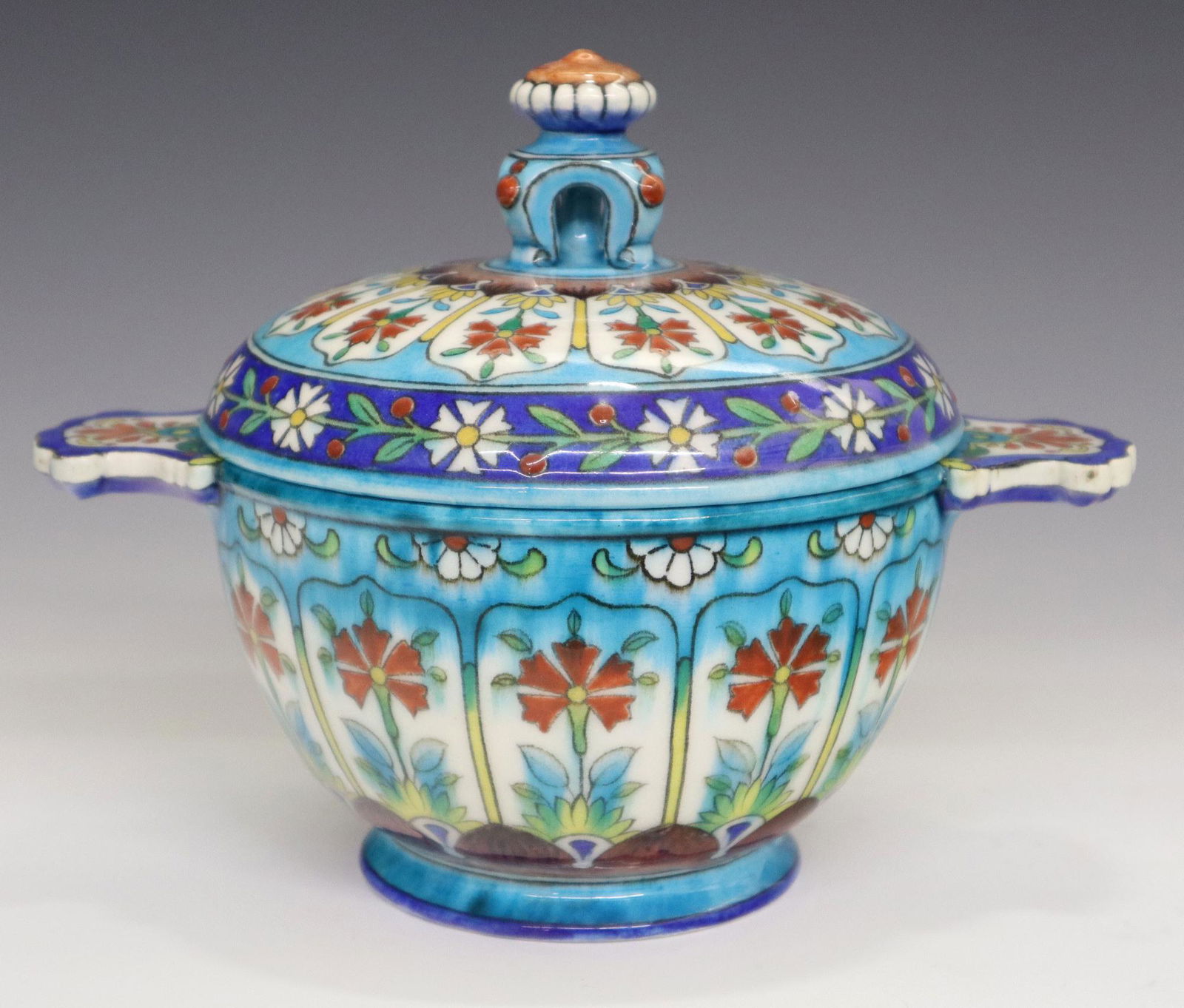 Th. Deck Covered Box: A Mid 19th Century Theodore Deck Glazed Earthenware Covered Box. Turkish inspired round covered box with architectural form knob and handles at either side is decorated overall with Iznik style flower