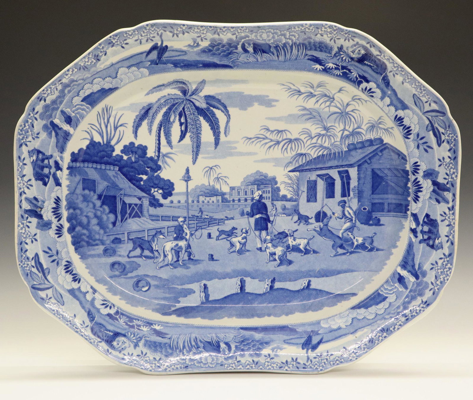 Indian Sporting Series Platter: A 19th Century English "Indian Sporting Series" Platter. Large octagonal blue and white transferware platter featuring "Dooreahs (or Dog Keepers) Leading Out Dogs" at the well, contained within a bord
