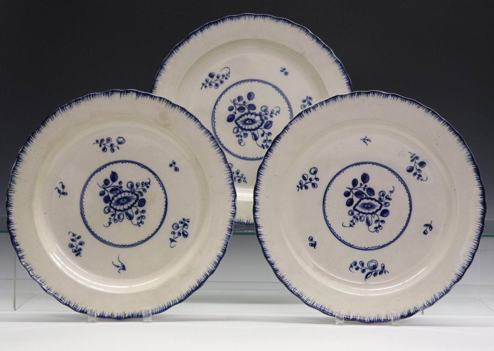 3 Spode Chop Plates: Three Late 18th to 19th Century Spode Chop Plates. Each creamware plate with blue foliate decoration at the well and blue feathered rim. Unmarked, but attributed to Spode; two with Chillingham Castle